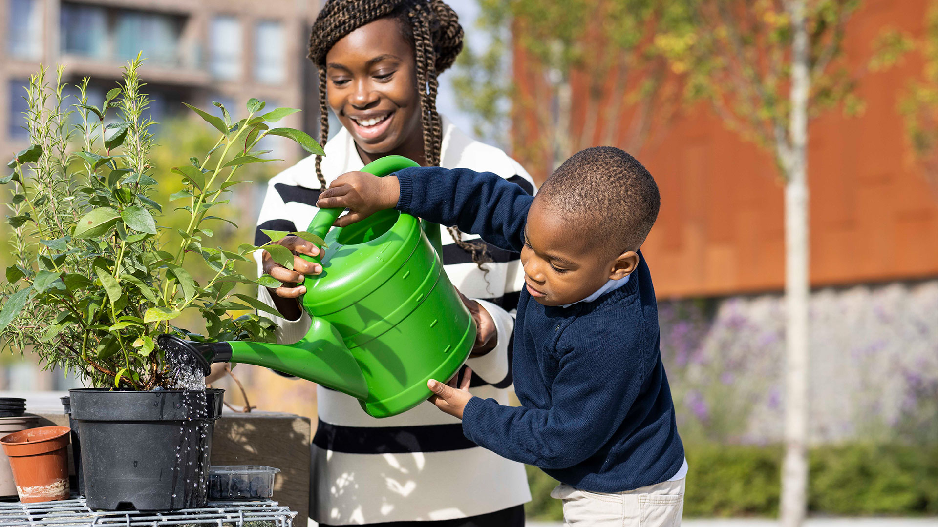 Residents watering plants in community garden